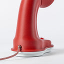 Rear view of the Nessi table lamp in Coral, we can see the cloth covered cord going into the brass inlet.