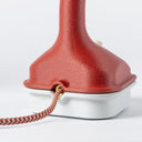 Back view of the Nimbus lamp in Coral, we can see the cloth covered cord going into the brass inlet.