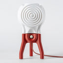 The Visitor table lamp in Coral on a white background.